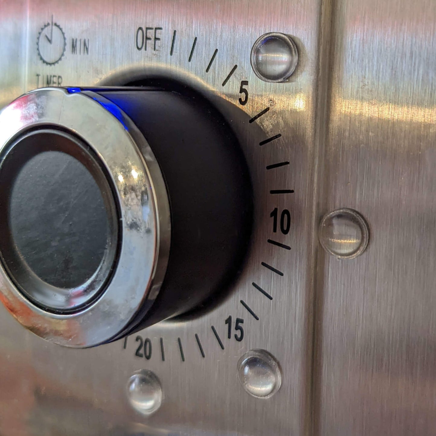 Mini domed bumper feet used on the dial of an electronic timer to act as tactical, raised markers for the blind or partially sighted.