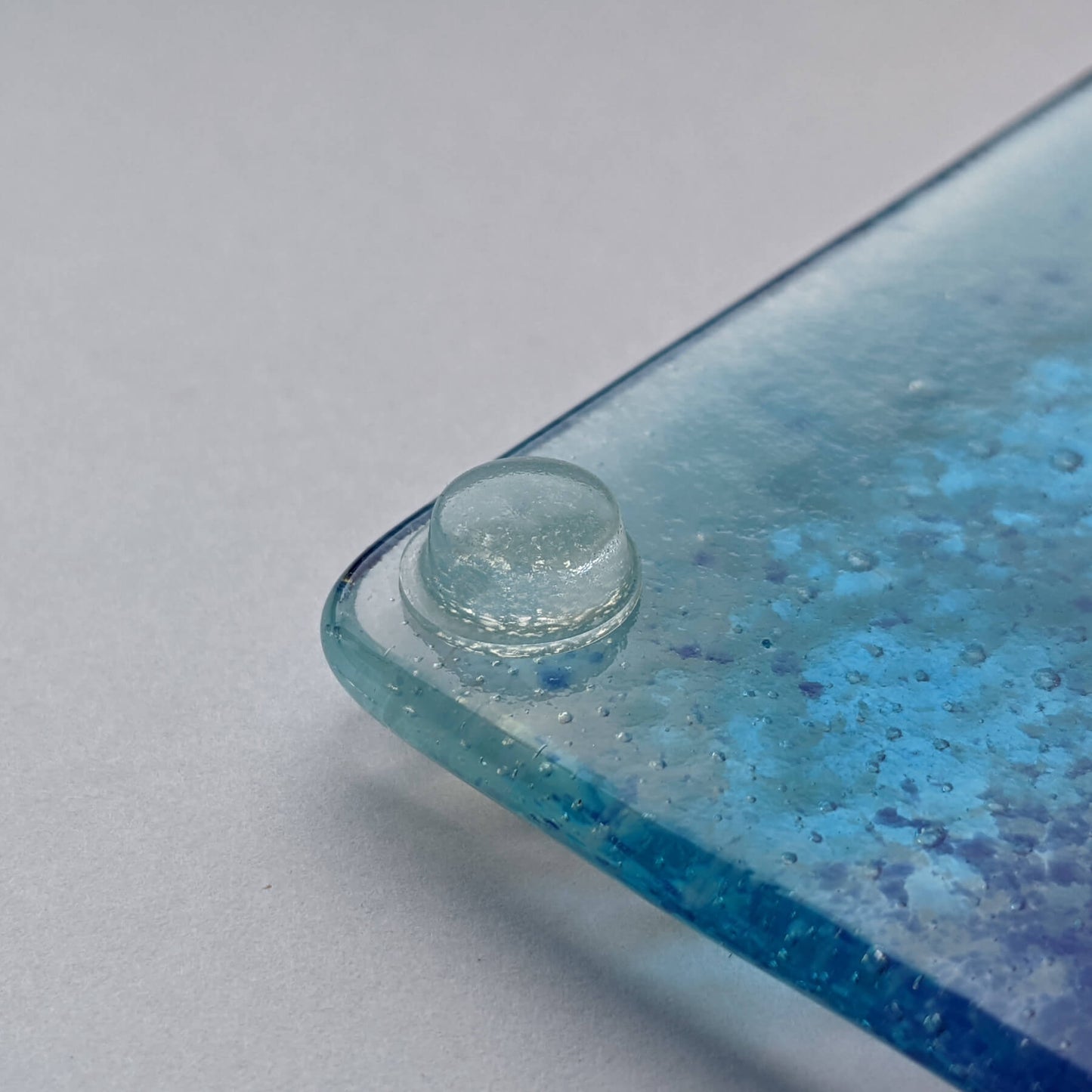 Clear bumper used on the corner of a glass coaster