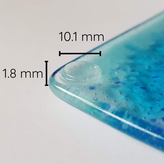 Measurements (10.1 mm x 1.8 mm) of the clear flat bumper pad.