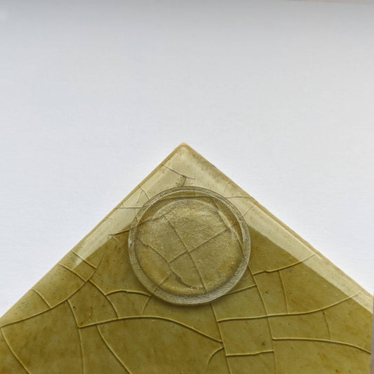 A low profile bumper pad used on the base of a green tile that has been made into a coaster.