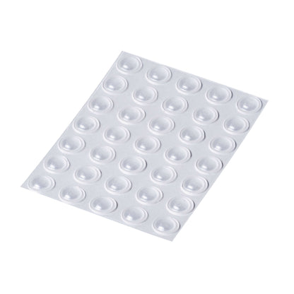 An adhesive backed sheet of 35 clear small domed bumper feet.