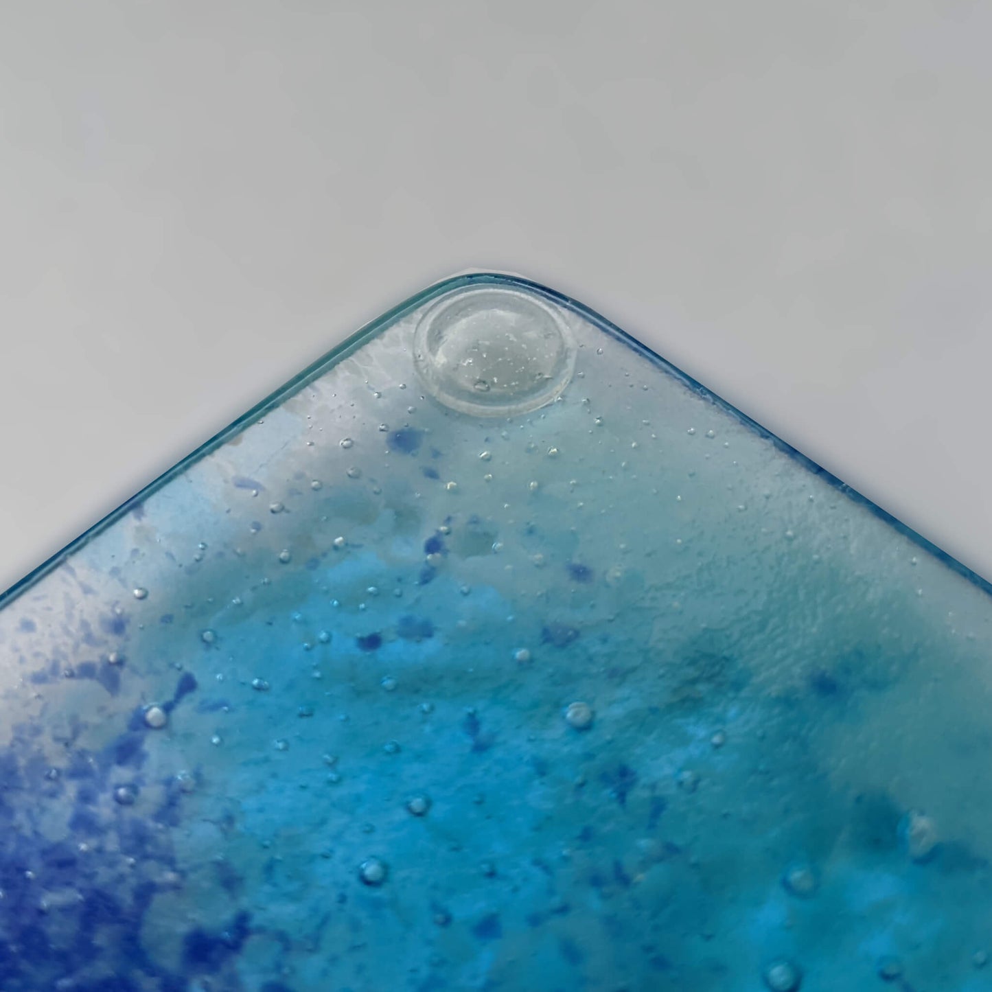 A single domed bumper used on a fused glass coaster to prevent sliding.