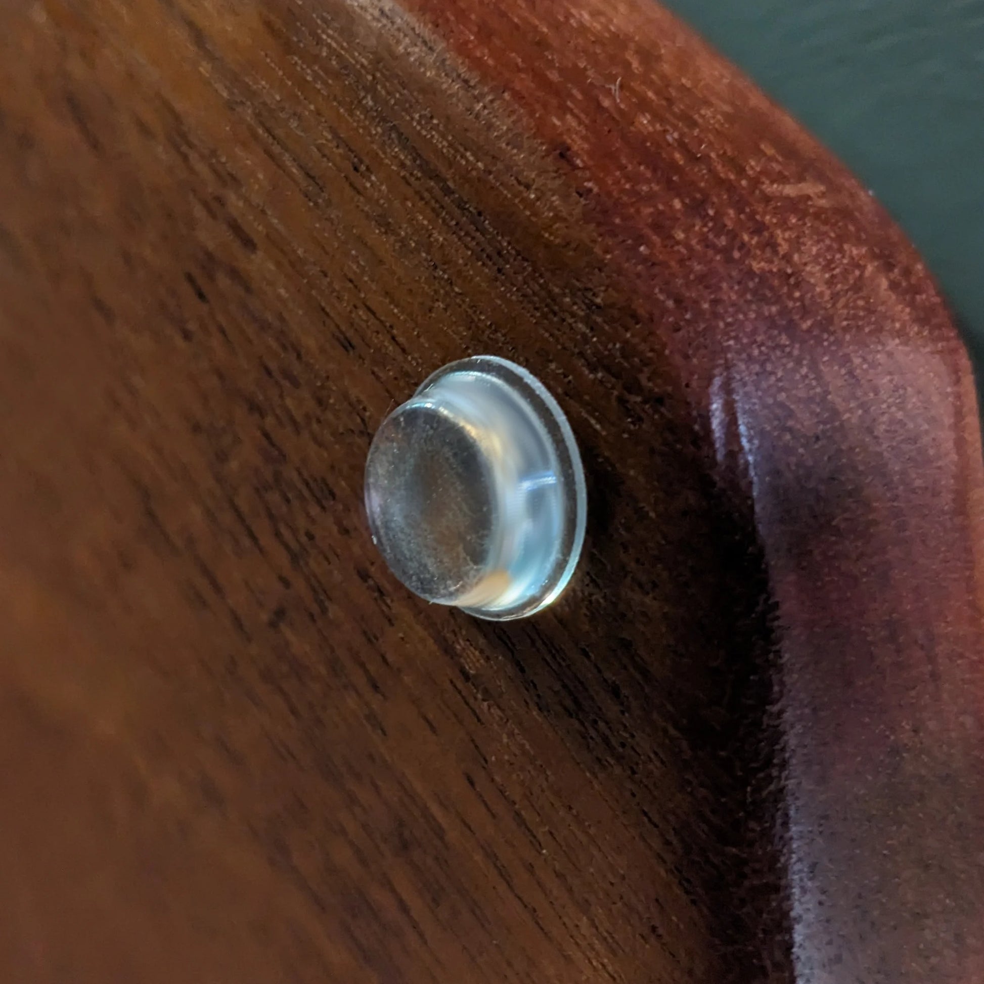 A bumper foot used on a wooden unit.