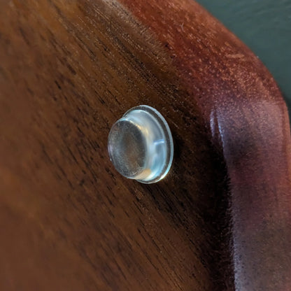 A bumper foot used on a wooden unit.