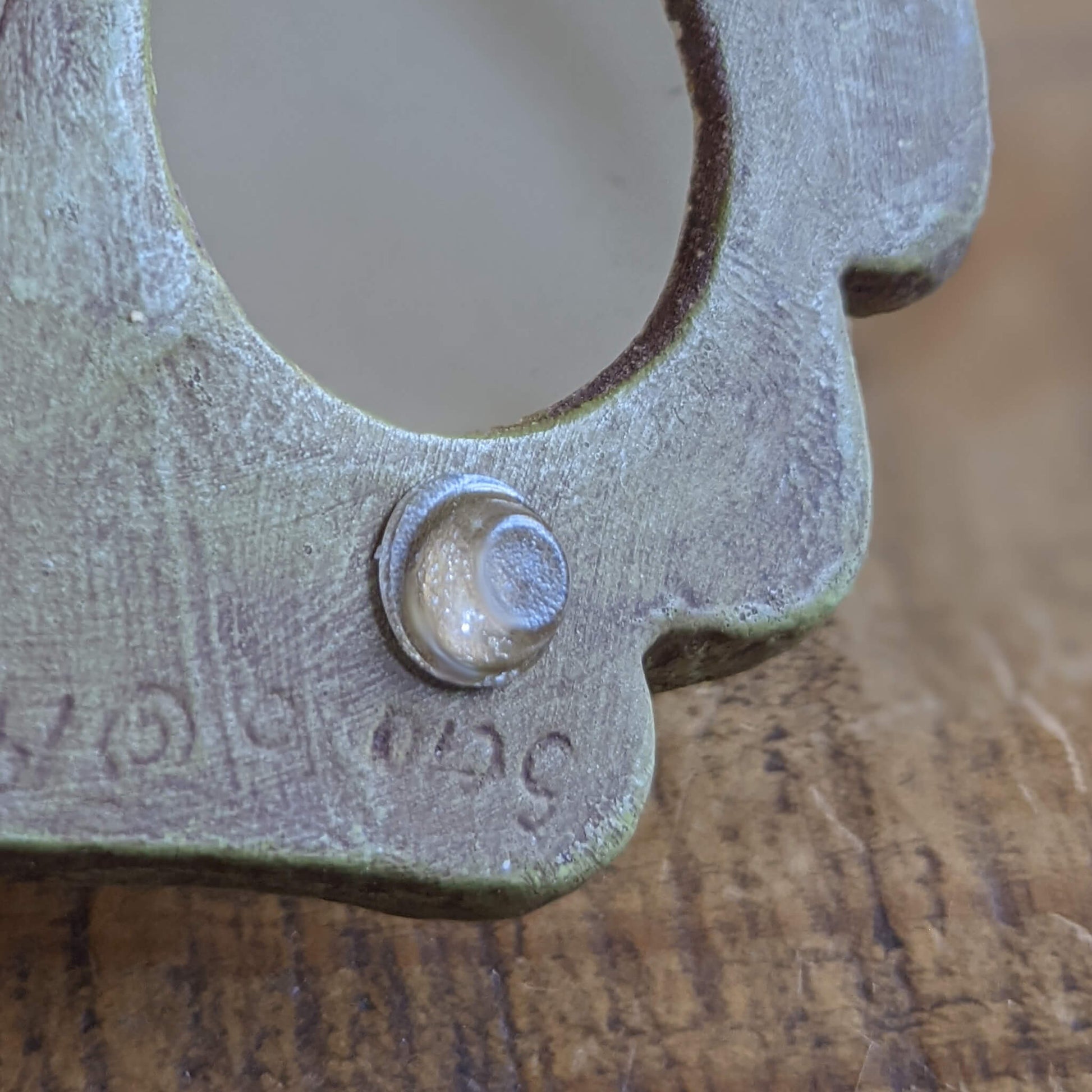 A mini clear flat bumper pad used on the base of a decorative ornament.