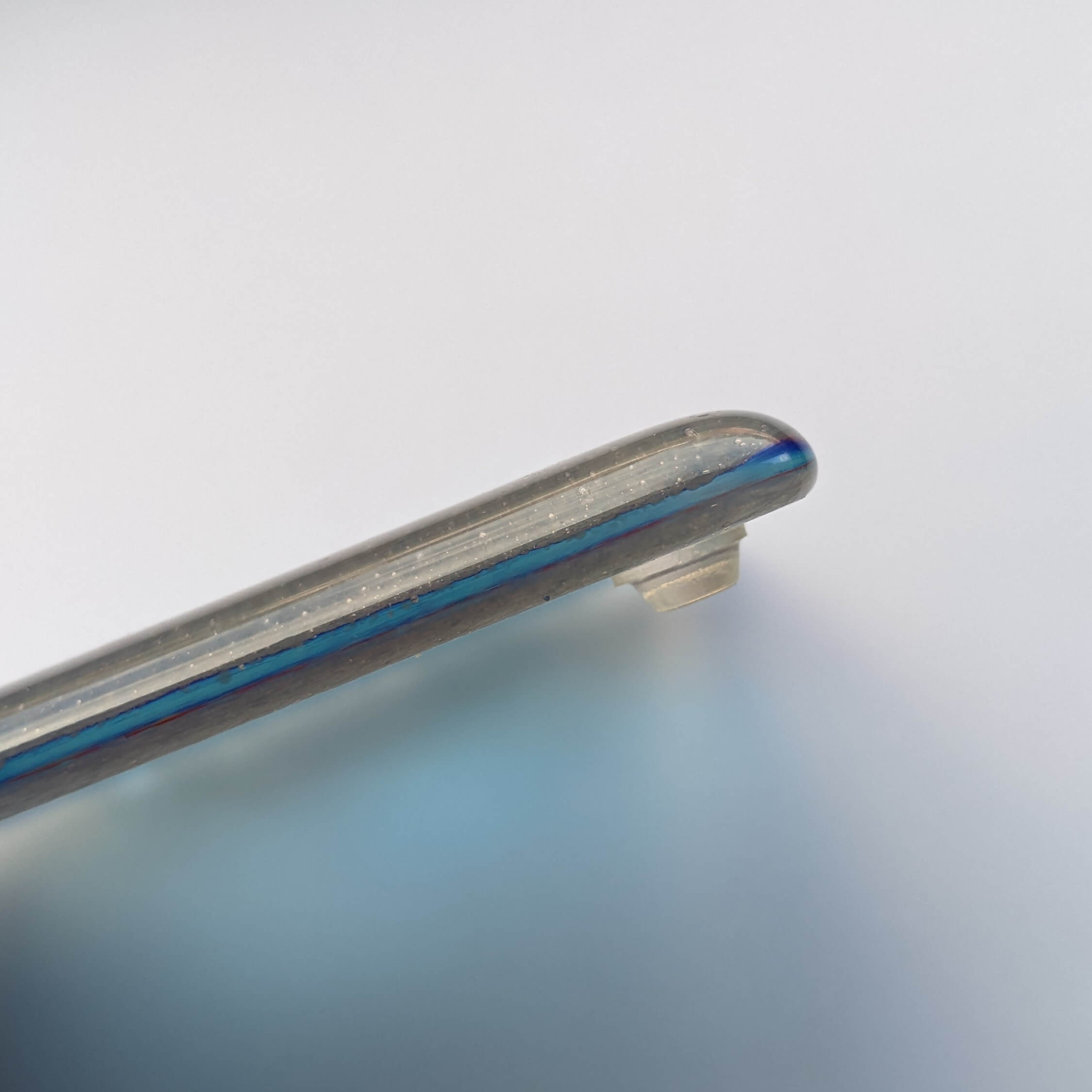 a clear mini sized bumper pad being utilised on the underside of a fused glass coaster. 