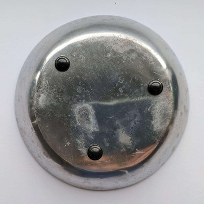 3 domed black bumper feet adhered to the base of a galvanized metal bowl.