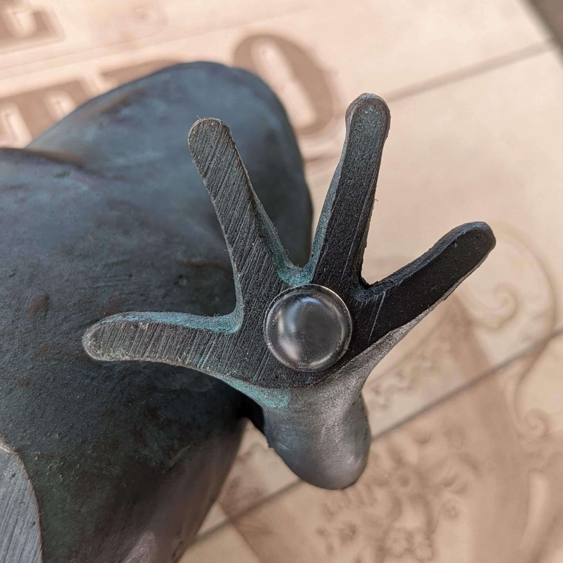 Clear domed bumper used on the base of a metal frog ornament.