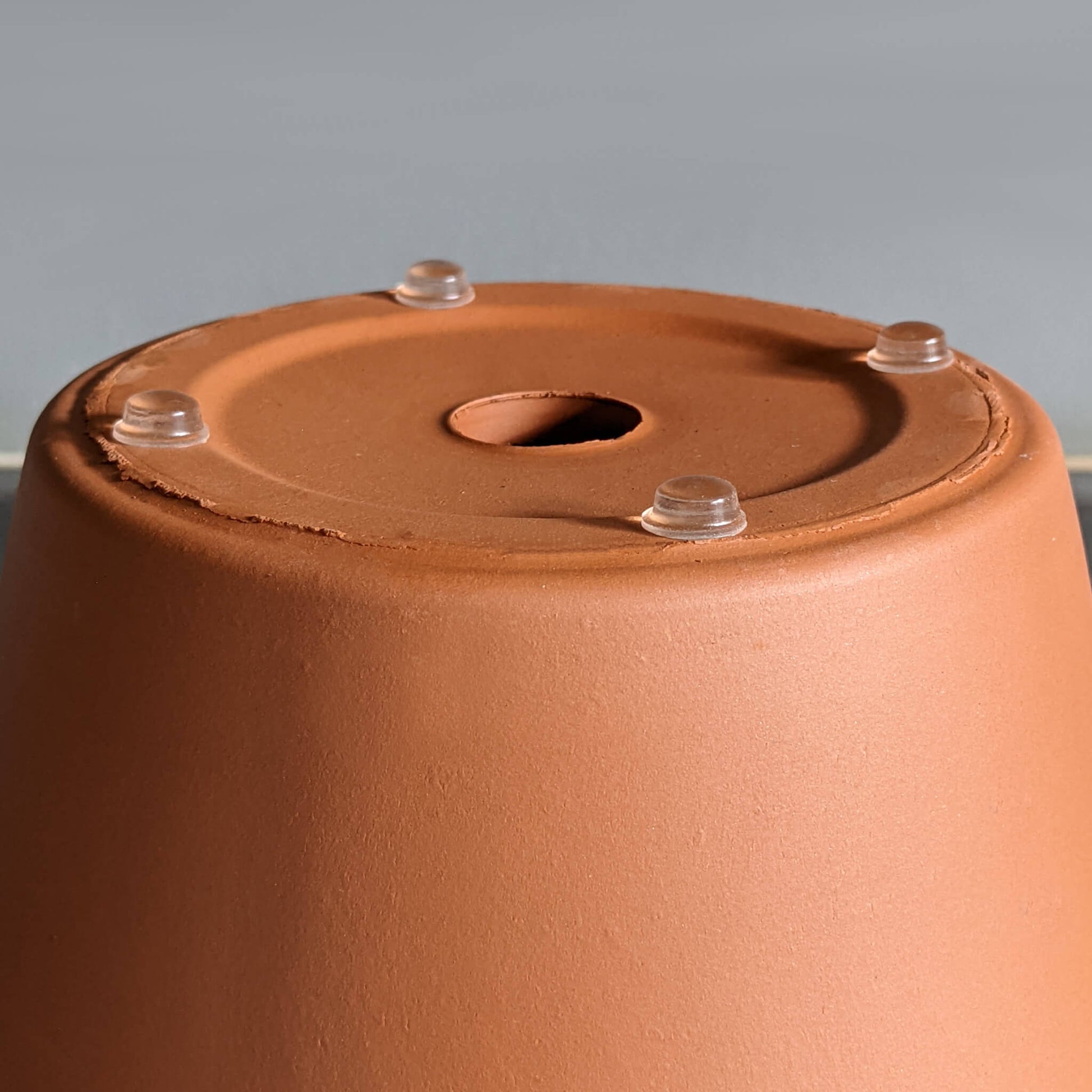 4 clear bumper feet used on a plant pot base