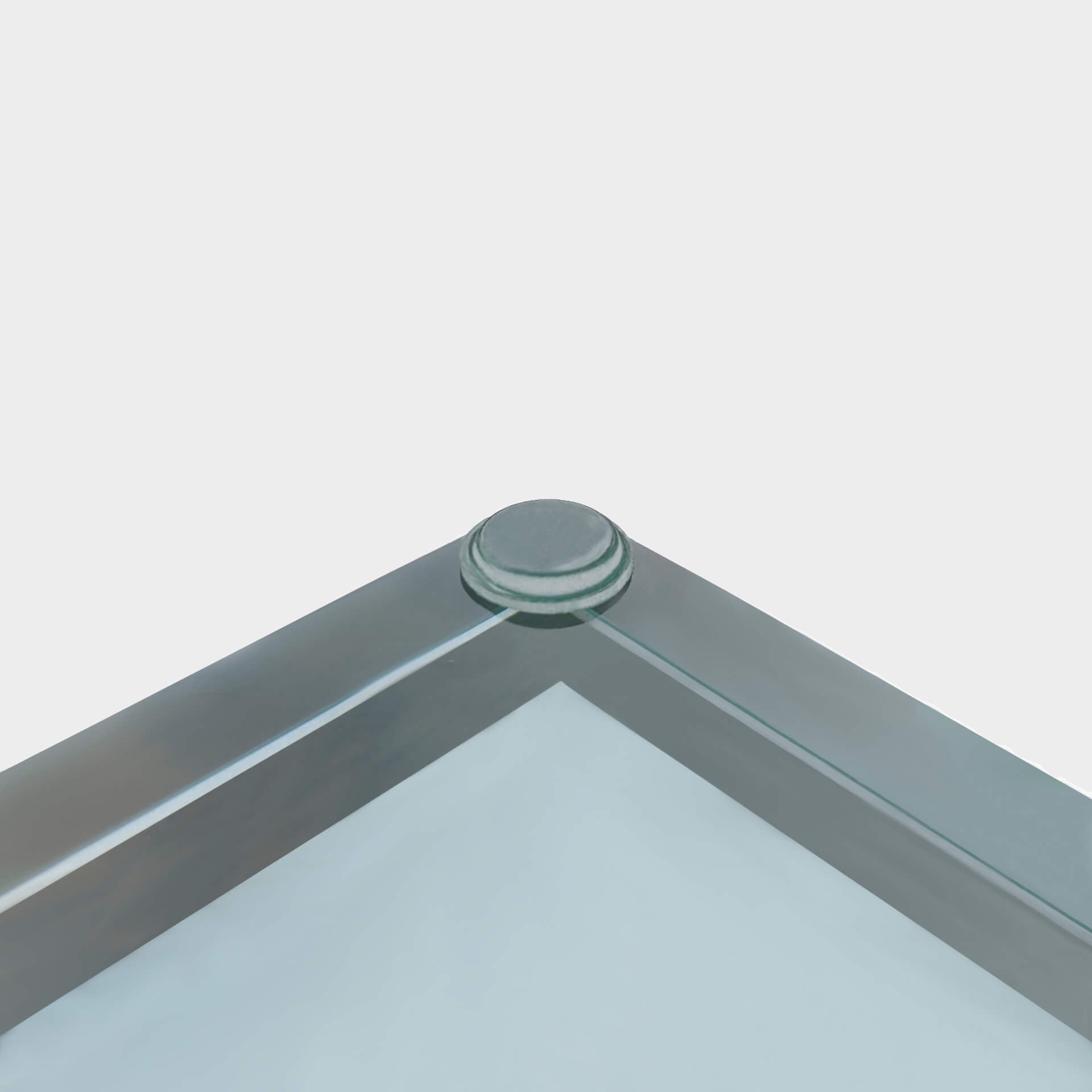 A glass bumper foot being used on a glass table-top.