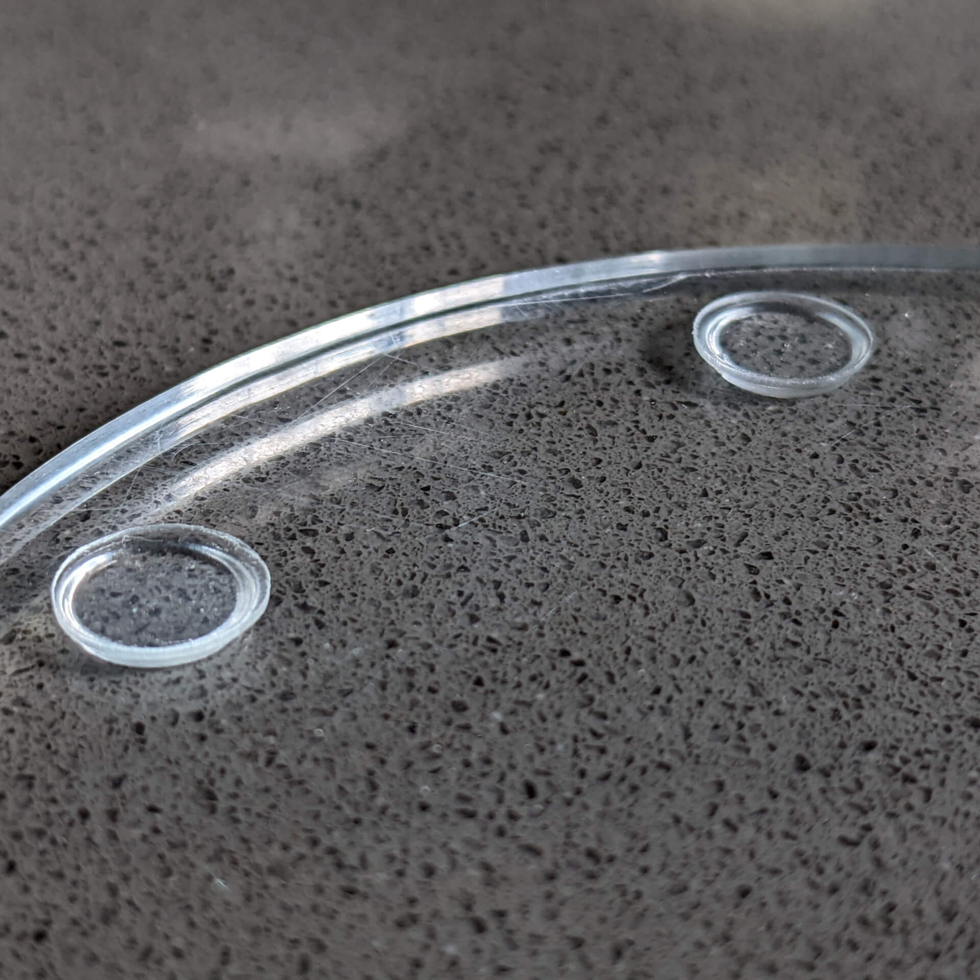 Bumper pads used as non-slip feet on a glass coaster.