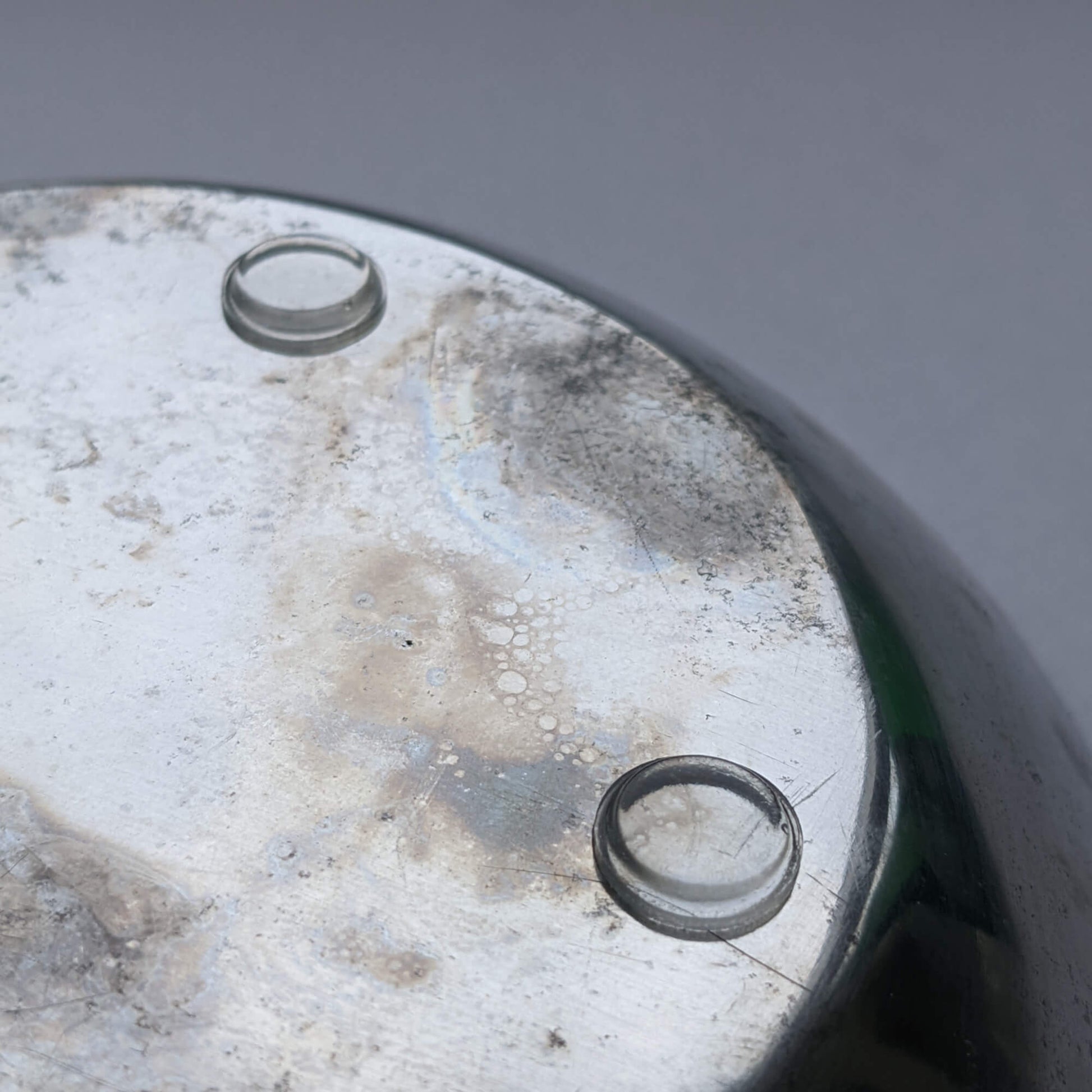 Bumper pads being used on the base of a galvanized metal bowl.