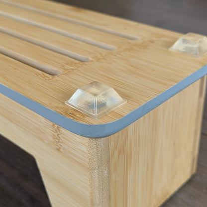 Chunky square flat topped bumper foot applied to a wooden chopping board rack base.