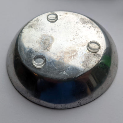 3 clear flat bumper pads being used on the base of a galvanized metal bowl.