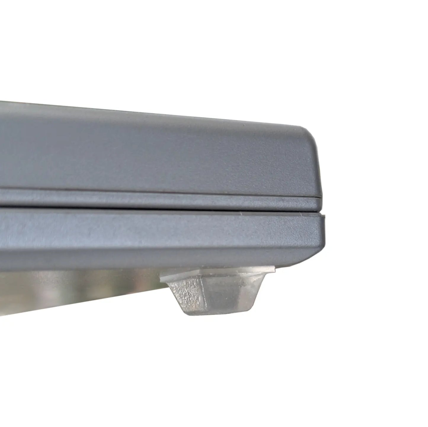 Close-up of a square bumper foot used on a set of electronic scales