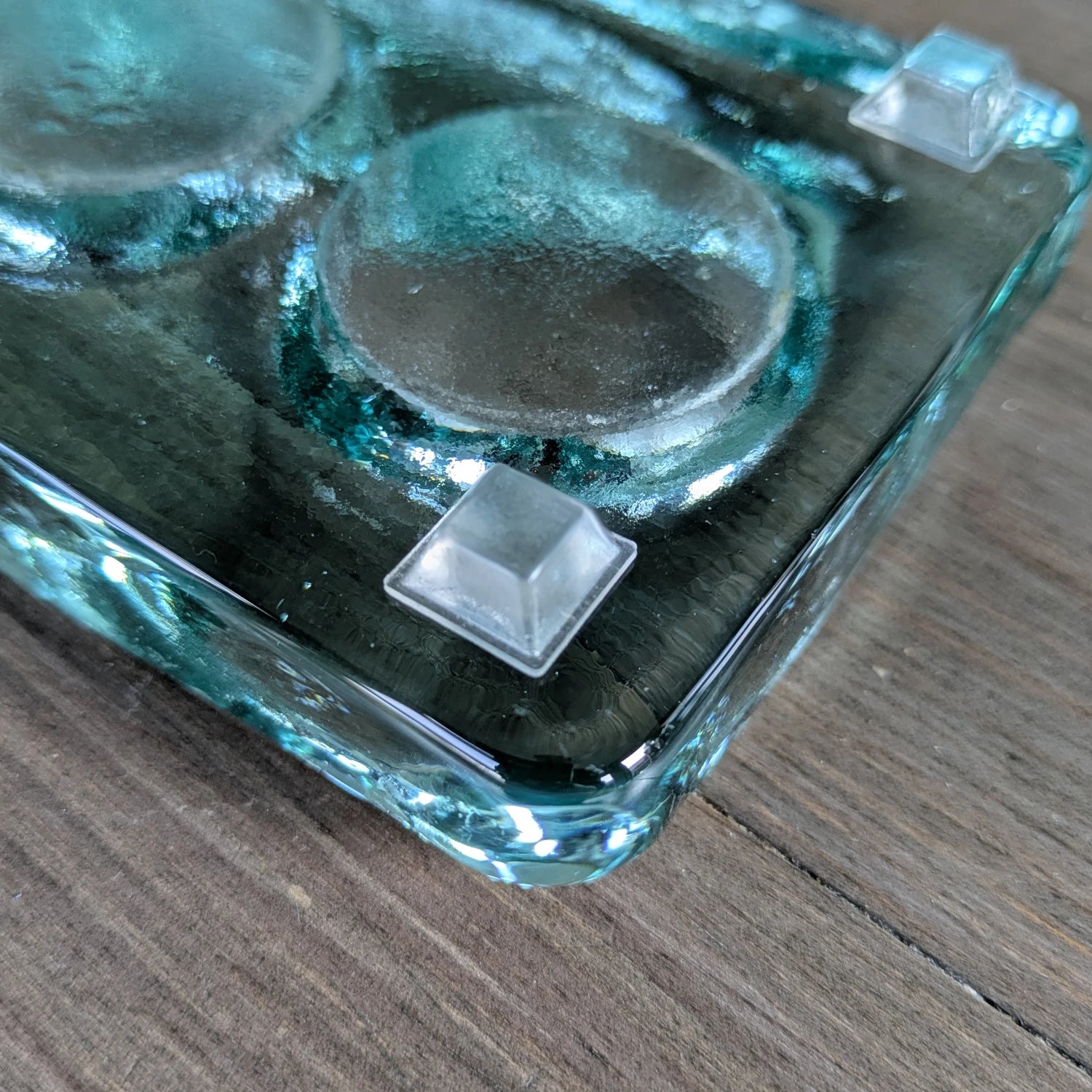 Square flat topped bumper feet used on the base of a tealight holder.