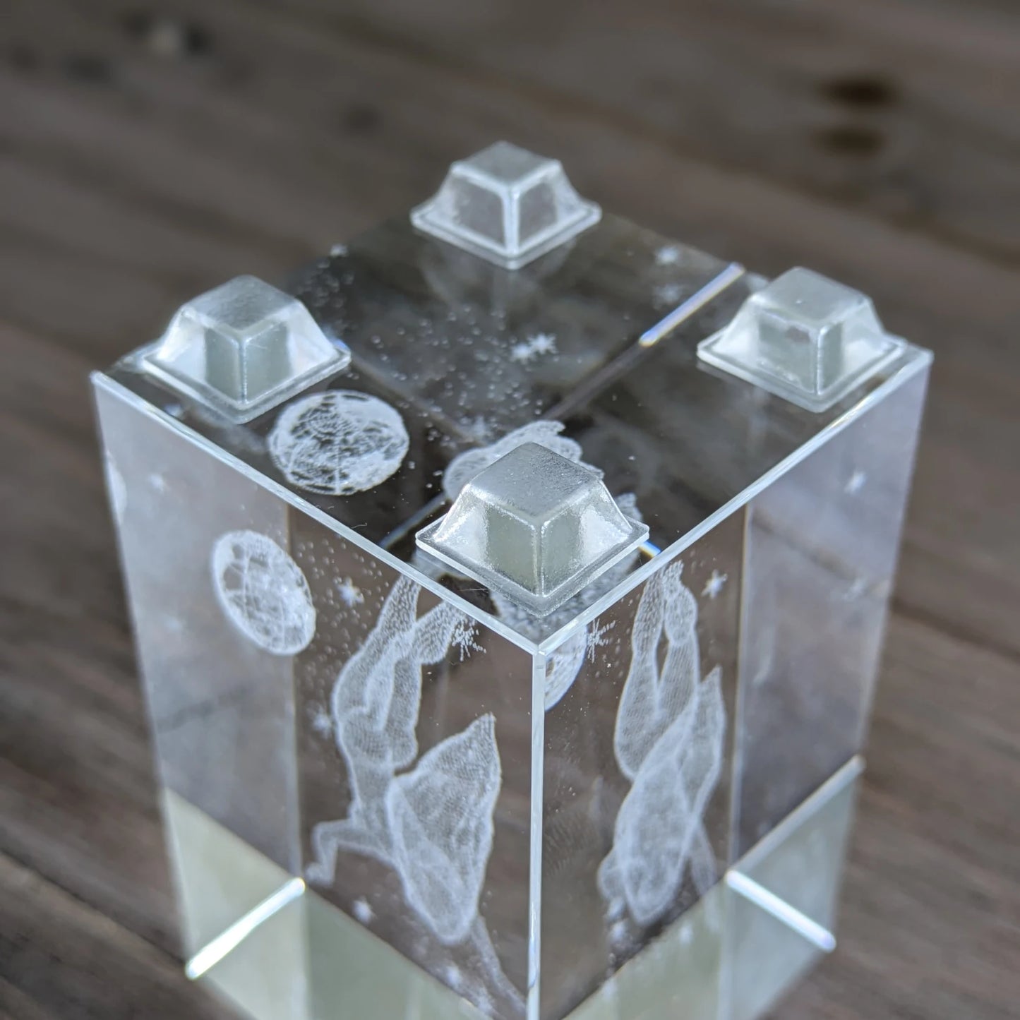 Four square flat topped clear bumper feet stuck to the base of a glass ornament.