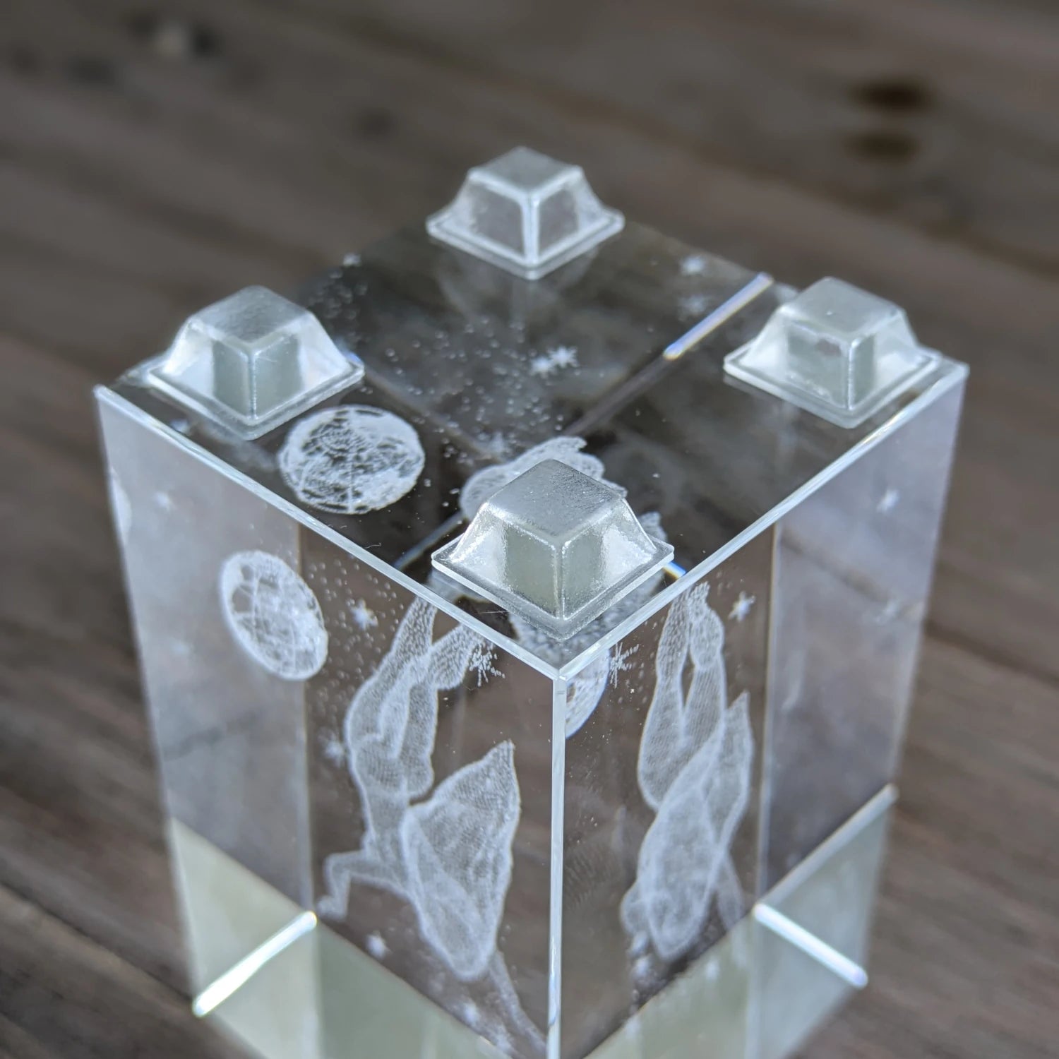 Four square flat topped clear bumper feet stuck to the base of a glass ornament.