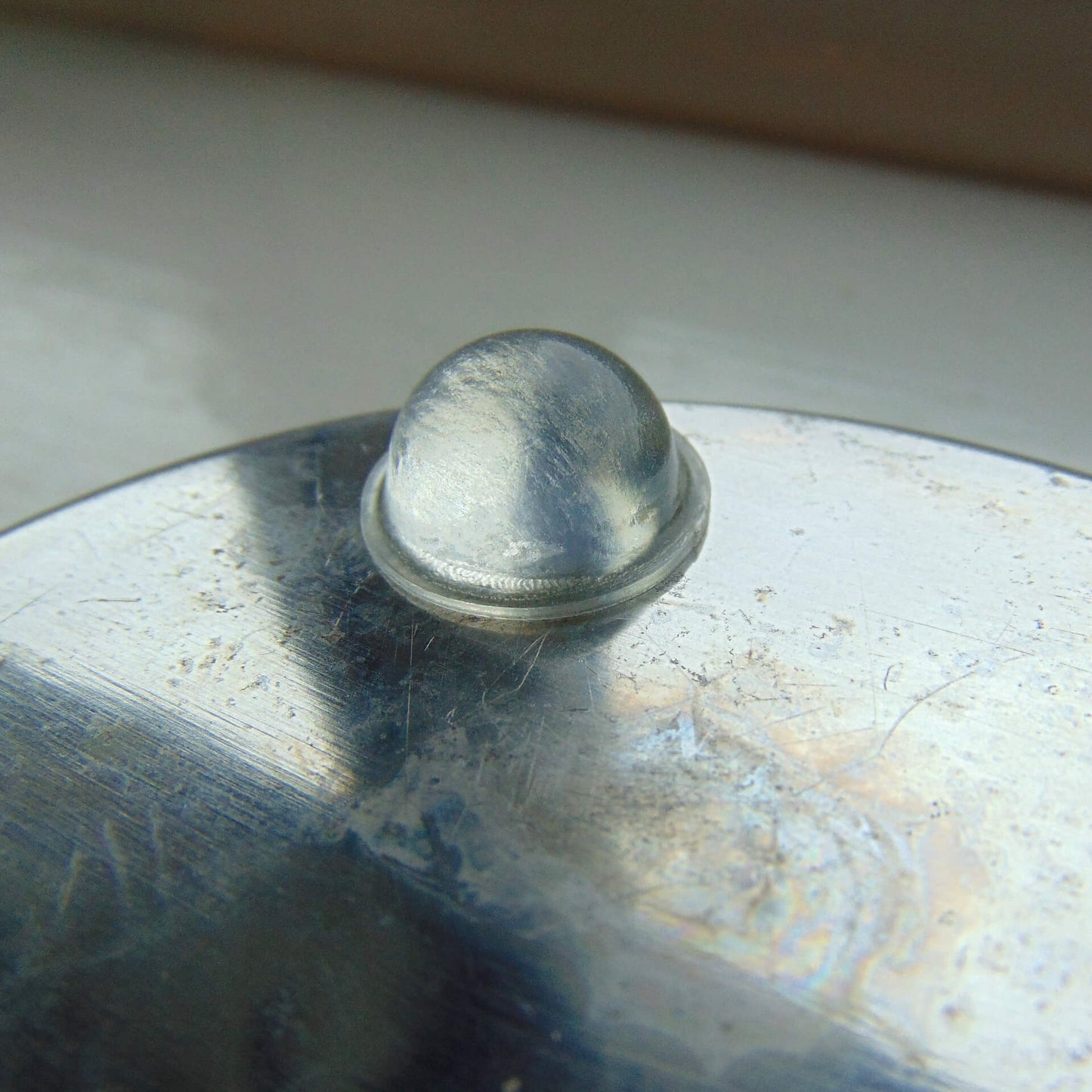 Domed bumper on a glass bowl base.