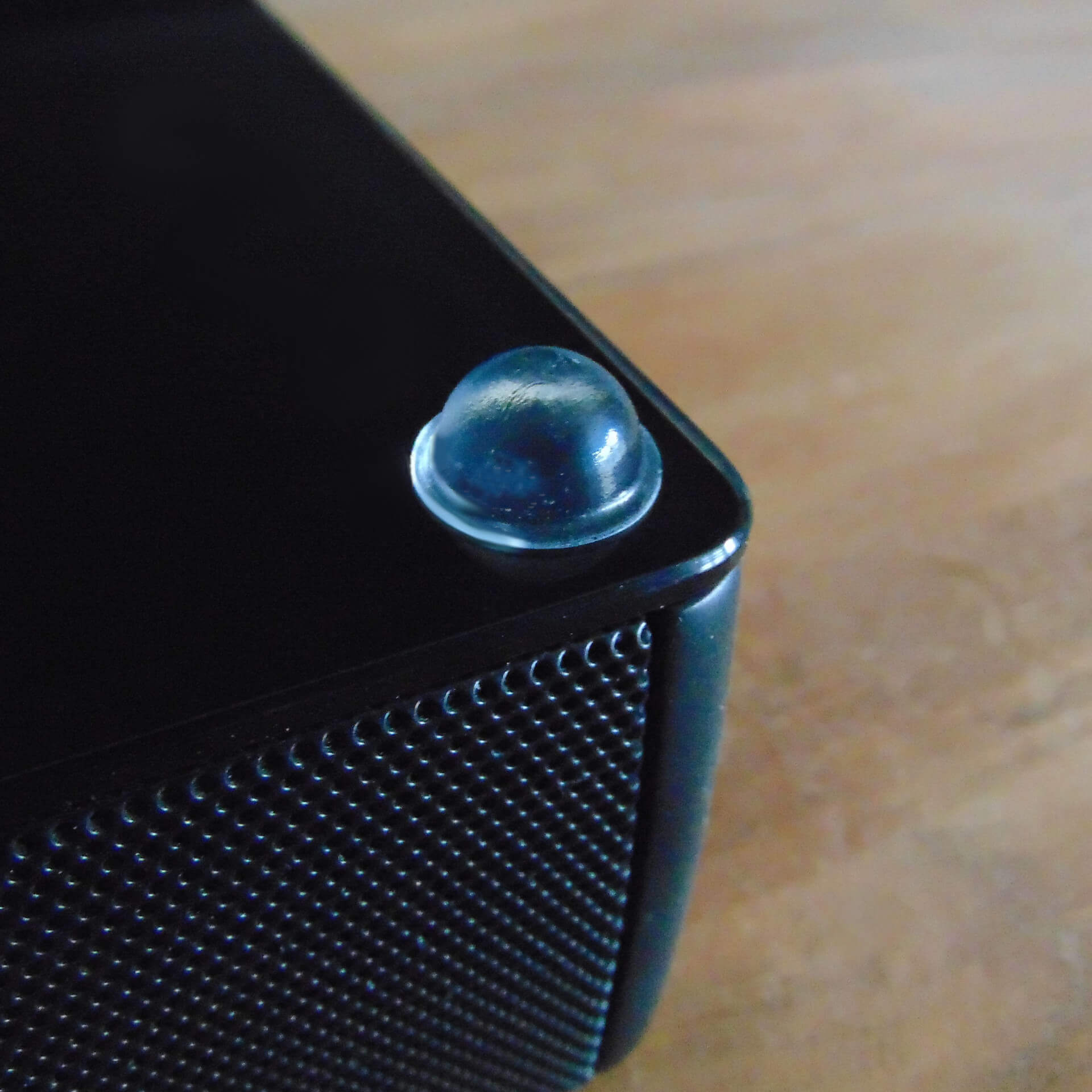 A single domed bumper used on the underside of a speaker system to enhance sound quality and prevent movement.
