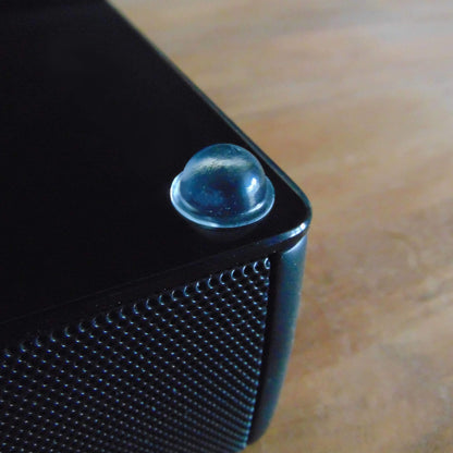 A single domed bumper used on the underside of a speaker system to enhance sound quality and prevent movement.