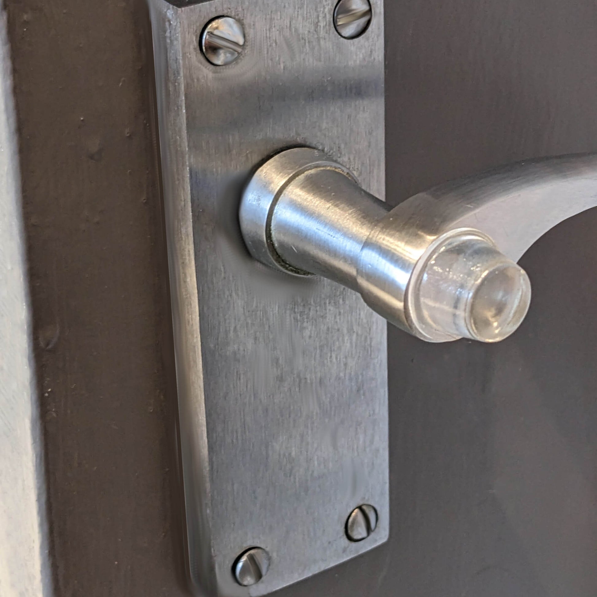 Bumper being used on a door handle to ensure no damage occurs when the handle hits the adjoining wall.