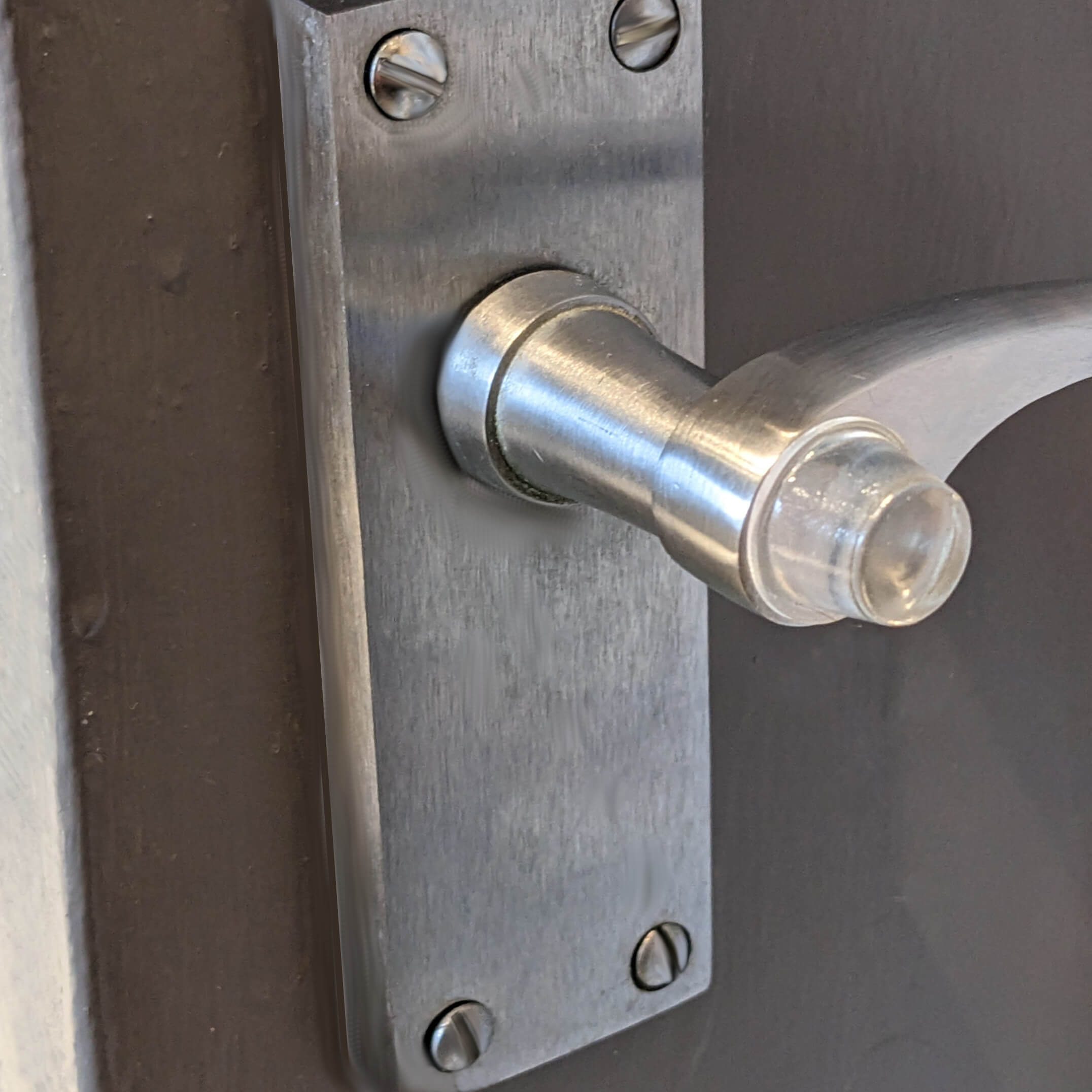 Bumper being used on a door handle to ensure no damage occurs when the handle hits the adjoining wall.
