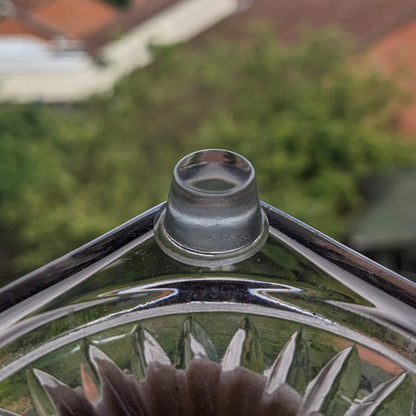 Clear flat bumper foot used on the corner of a glass candlestick holder.