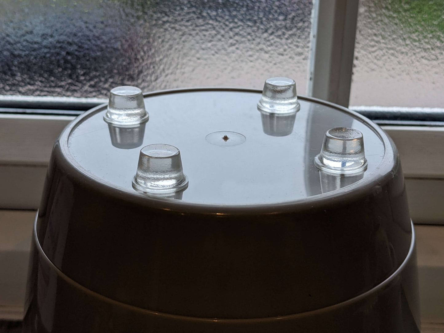 4 heavy duty tall bumper feet used on the base of a plant pot.