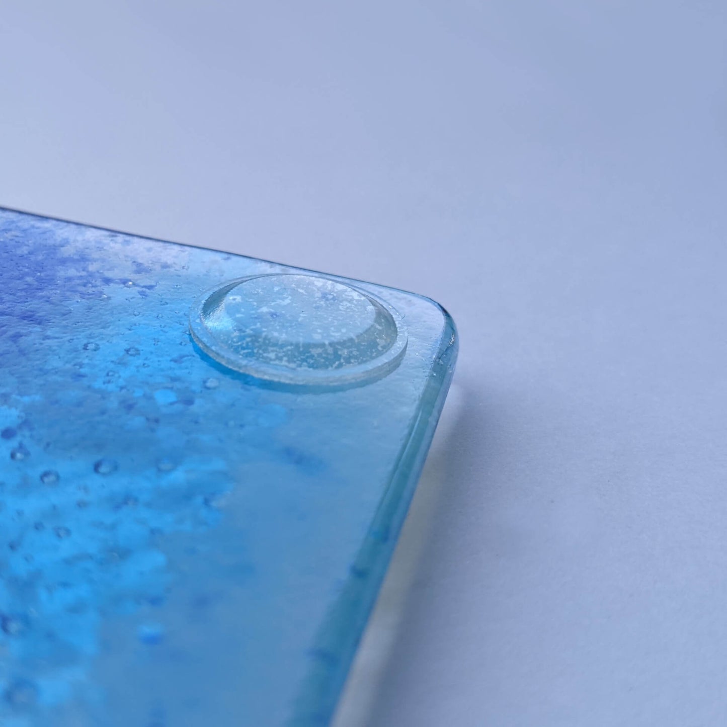 A low profile bumper used on a glass coaster.