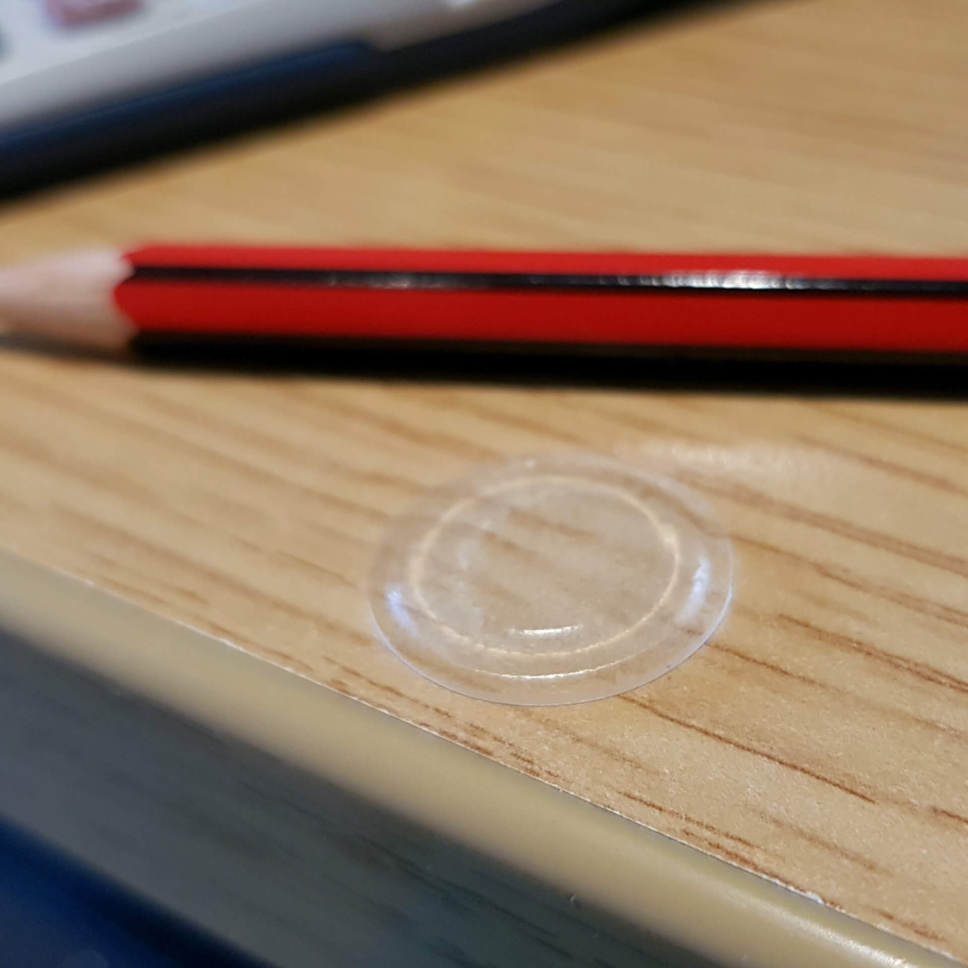 A low profile bumper used on a wood effect desk.