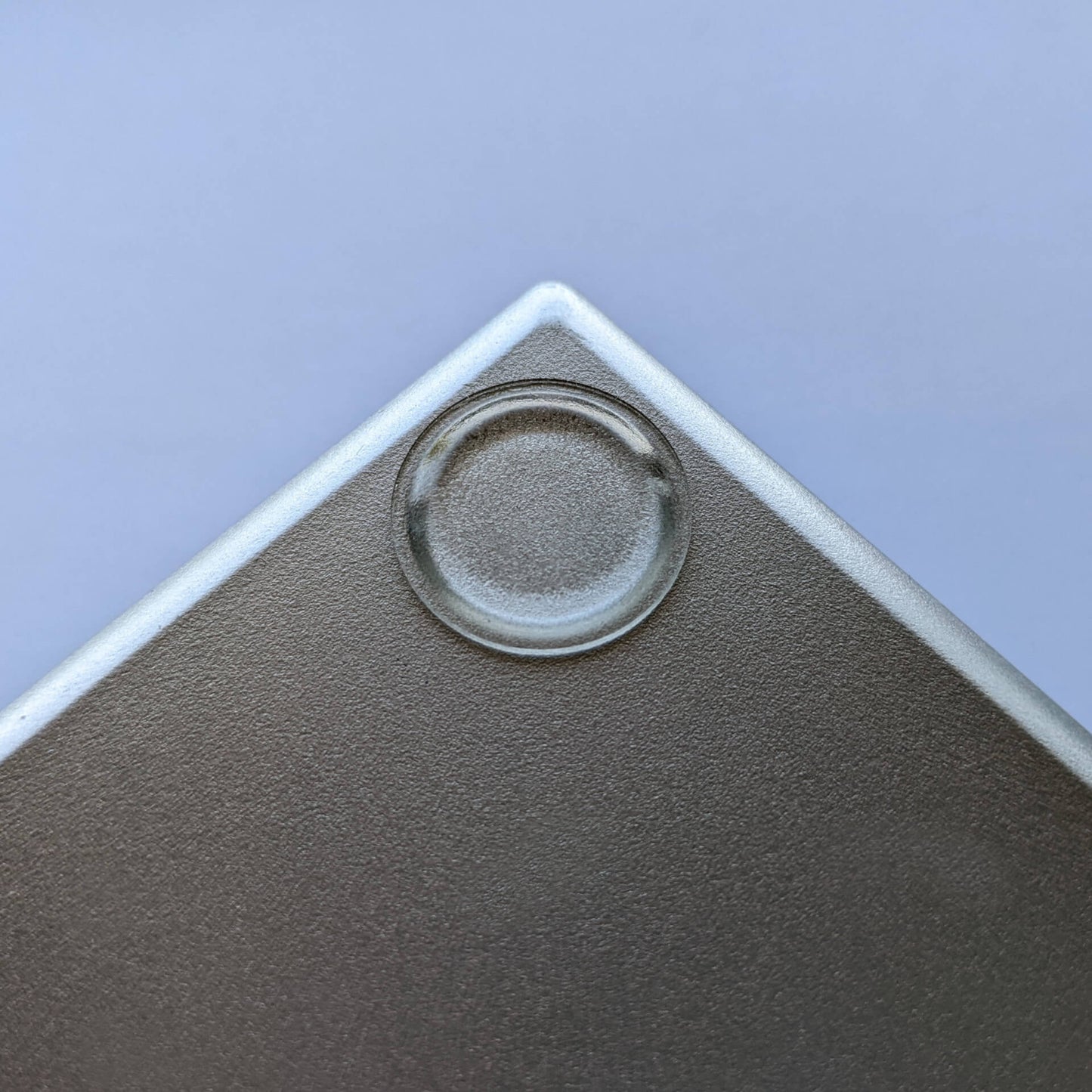A low profile bumper pad used on a plastic item.