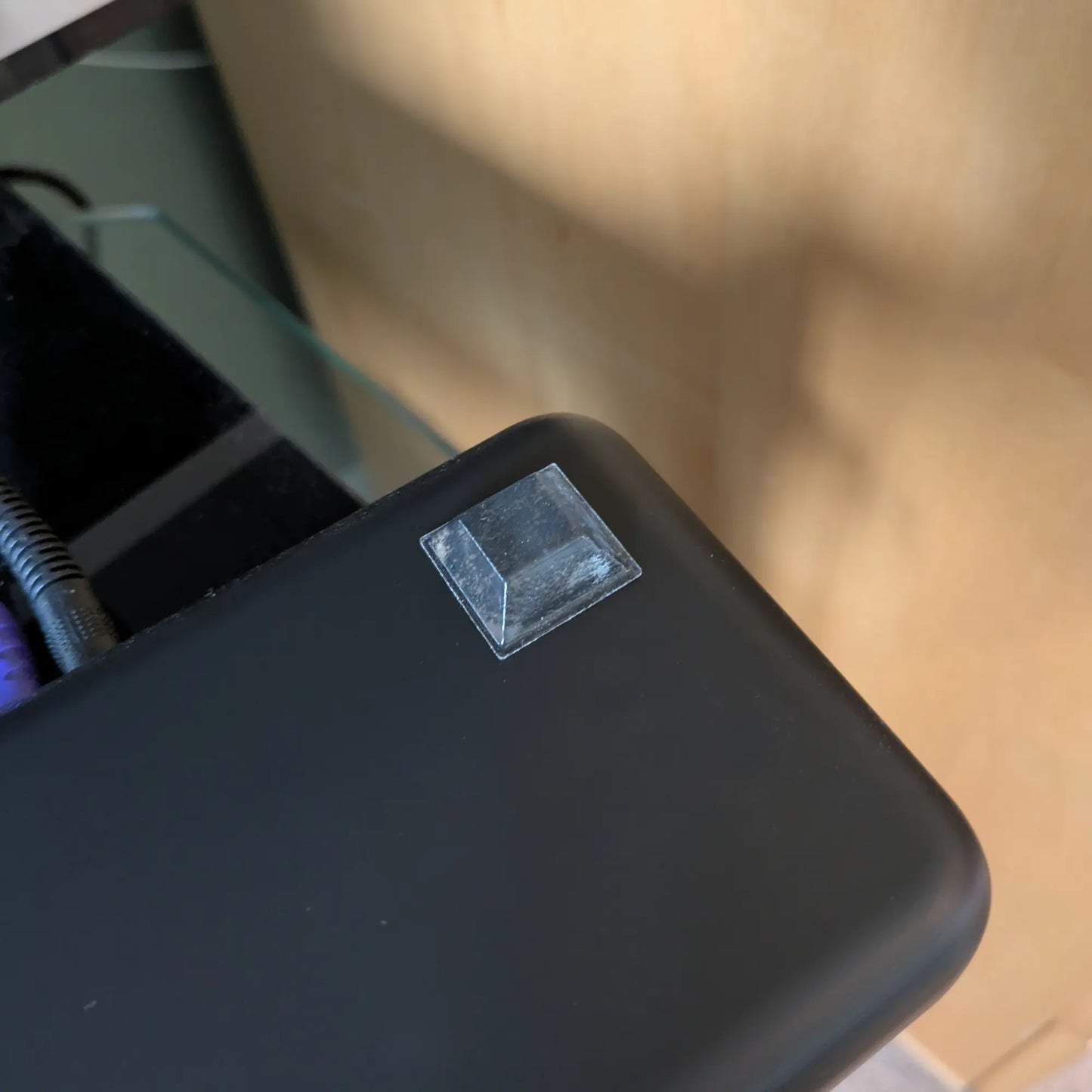 Black electronic device with a clear square bumper affixed