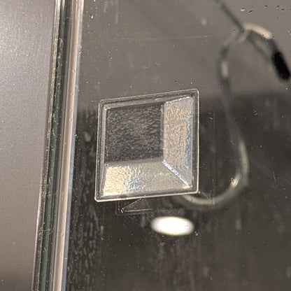 Close-up of a square clear bumper used on a glass surface