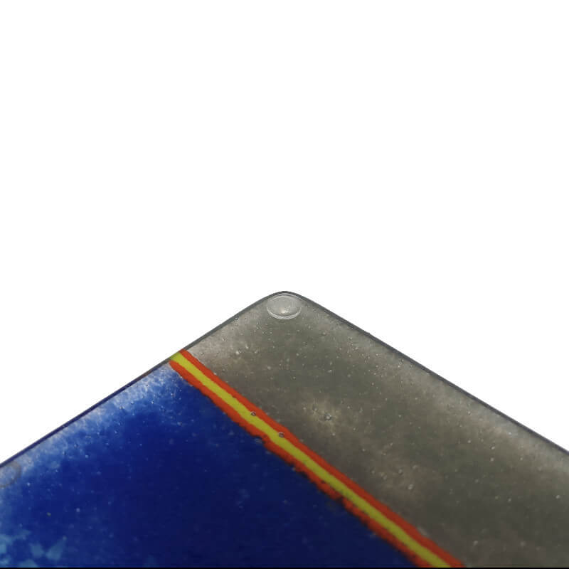 A single mini domed clear bumper dot used on the underside of a fused glass coaster.