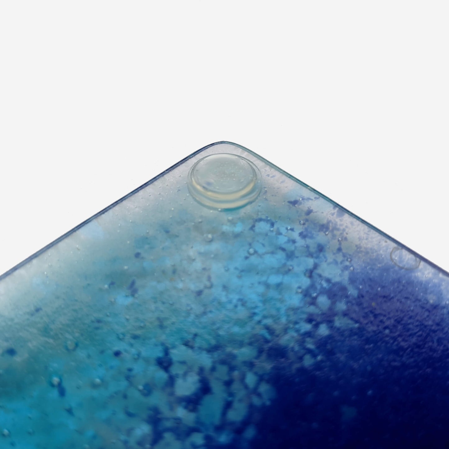 Clear flat topped bumper pad used on a glass coaster